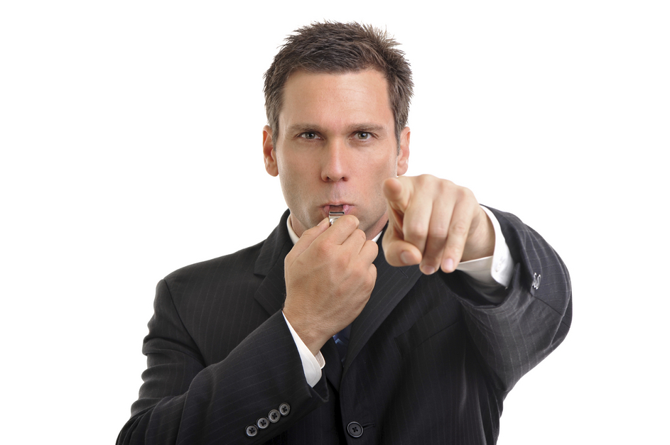 Businessman blowing whistle
